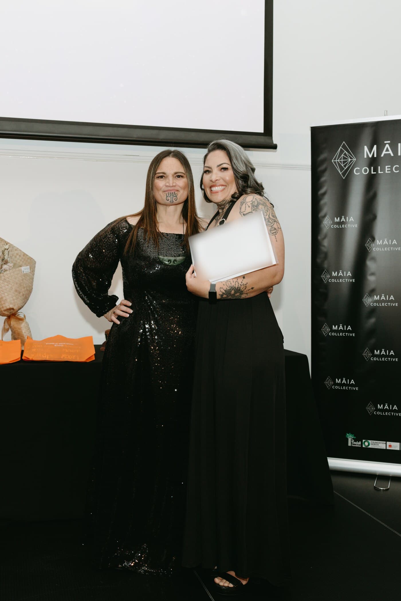 A wahine receiving her Te Tohu Paetahi certificate at the 2026 Māia Collective graduation